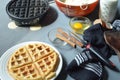 Waffle, waffle iron, bowl of batter, cinnamon sticks Royalty Free Stock Photo