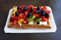 Waffle with whipped cream and fruits