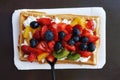 Waffle with whipped cream and fruits