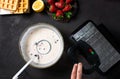 Waffles baking on a waffle maker close up Royalty Free Stock Photo