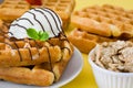 Waffles with chocolate sauce, ice cream and mint on yellow background Royalty Free Stock Photo