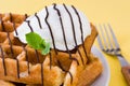 Waffles with chocolate sauce, ice cream and mint on yellow background Royalty Free Stock Photo