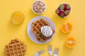 Waffles with chocolate sauce, ice cream and mint on yellow background Royalty Free Stock Photo