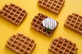 Waffles with chocolate sauce, ice cream and mint on yellow background Royalty Free Stock Photo