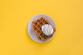 Waffles with chocolate sauce, ice cream and mint on yellow background Royalty Free Stock Photo