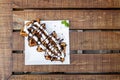 Waffles Closeup. Decorated Belgian Waffles with Whipped Creme and Chocolate Syrup ready to be served and consumed. selective focus