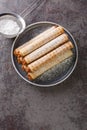 Waffles cones with boiled condensed milk in plate on table. Vertical top view Royalty Free Stock Photo