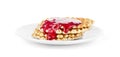 Waffles drenched raspberry jam on a white plate