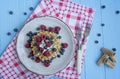 Waffles with fresh banana, raspberries, blueberries for breakfast. Belgian waffles. Light wooden background Royalty Free Stock Photo