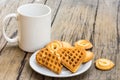 Waffles heart shaped and cookie on white plate and coffee cup