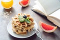 Waffles with honey and fruits and open notebook Royalty Free Stock Photo