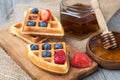 Waffles with honey, strawberries and blueberries Royalty Free Stock Photo