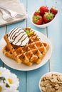 Waffles with ice cream on a blue wooden table Royalty Free Stock Photo