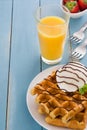 Waffles with ice cream on a blue wooden table Royalty Free Stock Photo