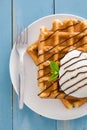 Waffles with ice cream on a blue wooden table Royalty Free Stock Photo