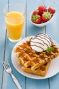 Waffles with ice cream on a blue wooden table Royalty Free Stock Photo