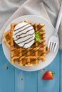 Waffles with ice cream on a blue wooden table Royalty Free Stock Photo