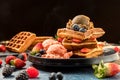 Waffles with ice cream, caramel sauce and fresh berries. Delicious Waffle with berry and ice cream at cafe. Royalty Free Stock Photo