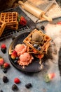 Waffles with ice cream, caramel sauce and fresh berries. Delicious Waffle with berry and ice cream at cafe. Royalty Free Stock Photo