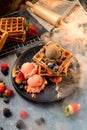 Waffles with ice cream, caramel sauce and fresh berries. Delicious Waffle with berry and ice cream at cafe. Royalty Free Stock Photo