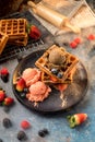 Waffles with ice cream, caramel sauce and fresh berries. Delicious Waffle with berry and ice cream at cafe. Royalty Free Stock Photo