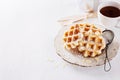 Waffles over white wooden background