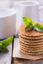 Waffles with peppermint and tea with milk for breakfast Royalty Free Stock Photo