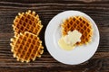 Waffles, plate with biscuit waffle poured condensed milk on table. Top view Royalty Free Stock Photo