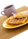 Waffles on plate and cup of tea