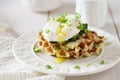 Waffles with poached egg and flowing yolk, cheese and spinach