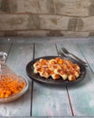 Waffles with powdered sugar on a small black plate on a wooden tray Royalty Free Stock Photo