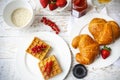 Waffles with red currant jam and berries, croissants, orange juice and oat flakes oatmeal Royalty Free Stock Photo