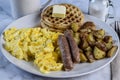 waffles with scramble eggs . sausage and home fries