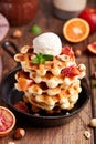 Waffles served with vanilla ice cream, hazelnuts and bloody oranges.