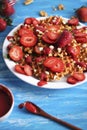 Waffles with strawberry on white plate on blue background. Royalty Free Stock Photo