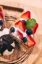 Waffles topping with slices of strawberry and blackberry served with hand pouring chocolate on a scoop of ice cream Royalty Free Stock Photo