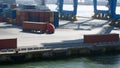 Wagon carries a large container in port terminal Royalty Free Stock Photo