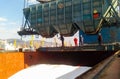 Wagon of the hopper for unloading on a cargo ship. Lifting operations in the port