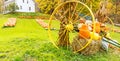 Wagon wheel, hay and pumpkins on farm in Fall