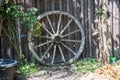 Wagon wheel leans against barn Royalty Free Stock Photo