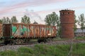 Wagons filled with slate and an old red brick water tower. Royalty Free Stock Photo