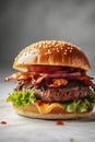 Wagyu beef burger with crispy fried bacon lettuce onions and melted cheddar cheese between toasted buns on wooden board