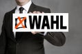 Wahl in german Election sign is held by businessman