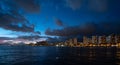 Waikiki Beach at sunset with dark blue and pink clouds in the sky Royalty Free Stock Photo