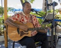 Waikiki, Honolulu, Hawaii - Oct 31, 2021-Man plays acoustic guitar for street entertainment Royalty Free Stock Photo