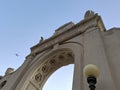 The Waikiki Natatorium War Memorial at dusk with plane in the sky