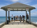 People at the end of Waikiki beach cement pier Royalty Free Stock Photo