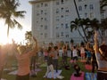 People raising arms in the air as they do yoga at Vino and Vinyasa event