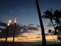 Torches, the moon and palms make a great Wailea Sunset Royalty Free Stock Photo