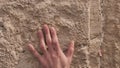 Wailing Wall or Western Wall in Jerusalem. Close-up of a hand tuching stones Western Wall or Kotel.